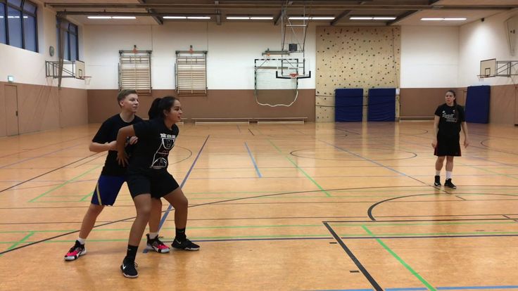 Basketball players practicing boxing out technique during rebounding drills